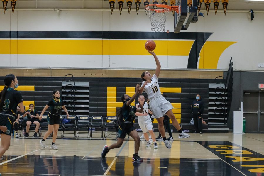 Sophia Bertolo on the fast break rising up for a lay up against Moreau Catholic high school at the Jim Feria tournament in early December.