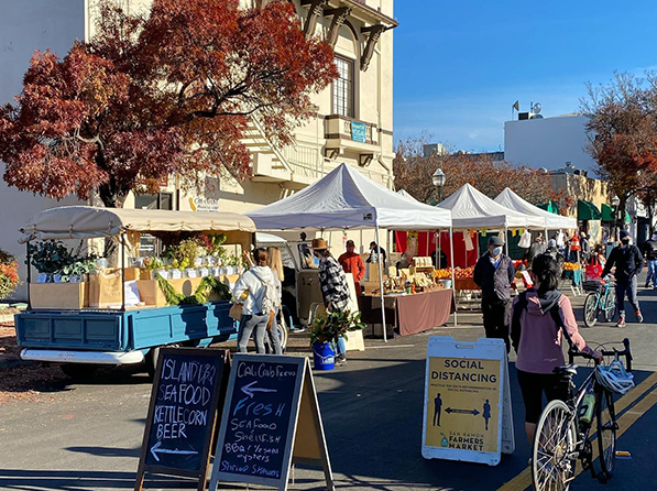 The Livermore Farmers Market tents lining down Second Street on Sunday, January 9, with the Poppy Flower Truck on the left.