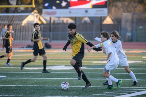 Cristian Franco dribbling the ball forward during a home game against San Ramon Valley high school