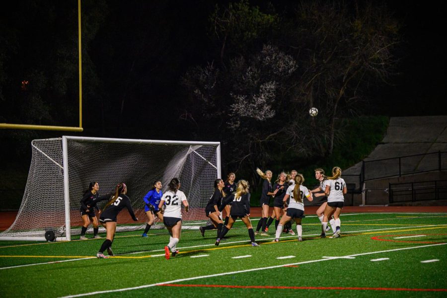 Siena Quierolos corner kick in the air and on the way to being headed in for a goal by Jordan Knight.