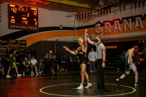 Naeem Salemi holding his hand up after defeated his Livermore high opponent in the duel meet at Granada.
