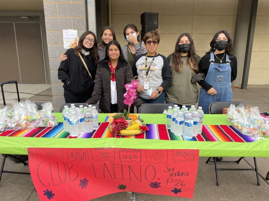 Club adviser Mrs. Ventura and other club members at the Latino Club table in front of the gym.