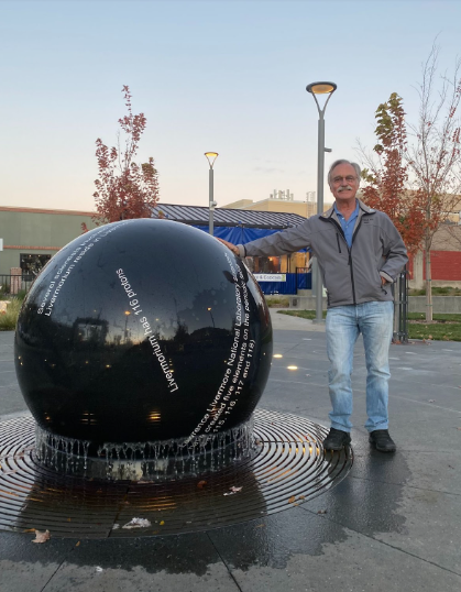 Mayor-elect Marchand leaning up against the water feature at the newly opened Livermorium Plaza.