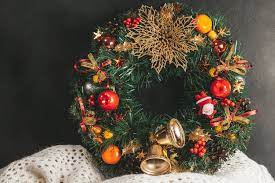 Green wreath with fruits, bells, and golden leaves