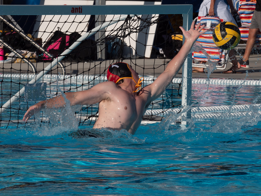 Goalie Gavin Bates dives for the ball to save a goal.