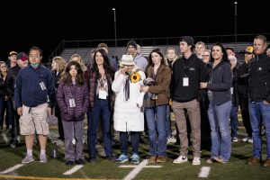 Former principal Kevin Drake's loved ones attending the announcement of the stadium's dedication to him