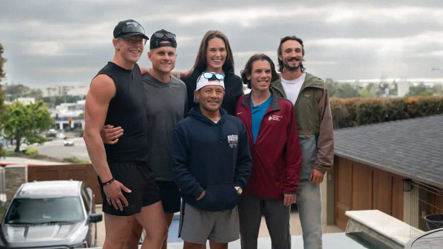 The six athletes gather on Solana Beach for a photo before the race begins.