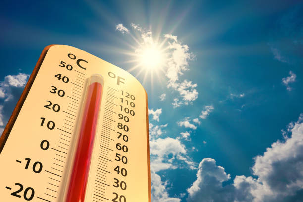  Low angle view Thermometer on blue sky with sun shining in summer show increase temperature, concept global warming


