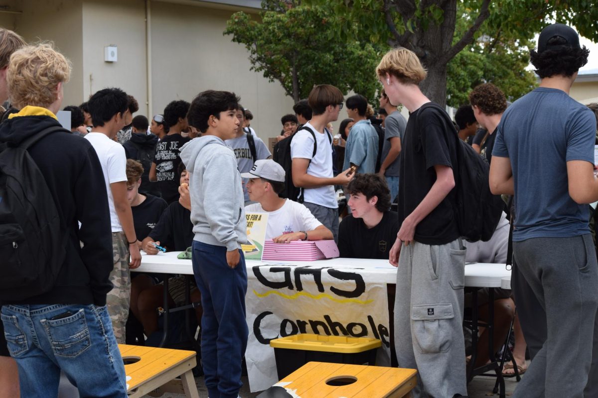 Students playing cornhole with GHS Cornhole Club