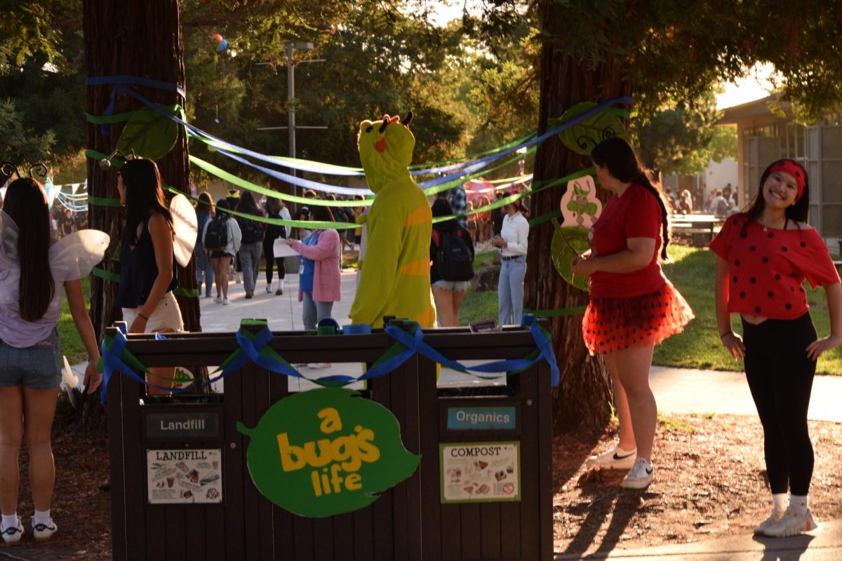 Senior dressed up as bugs life welcoming students at the entrance.