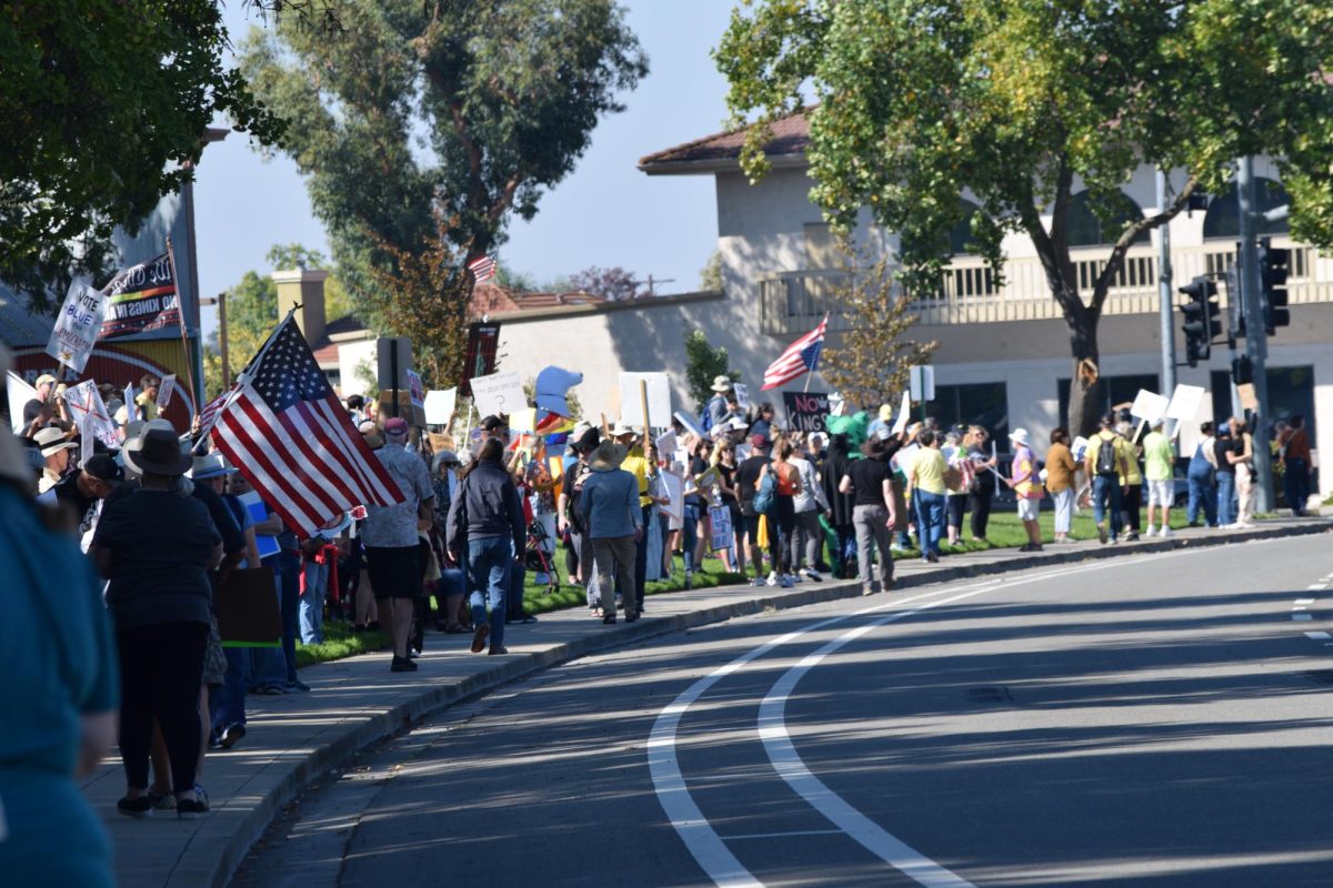 Protestors lining up the sidewalk of Portola Avenue.