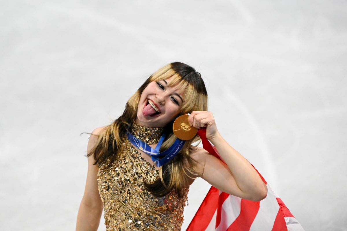 Alysa Liu holding her gold medal she won for women's singles figure skating